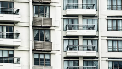 Modern city apartment hotel exterior with spacious family-friendly suites, contemporary architecture, and an urban skyline ba