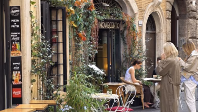 Historic Rome cafe exterior on a cobblestone street, capturing Italian coffee culture, old-world architecture, and food touri
