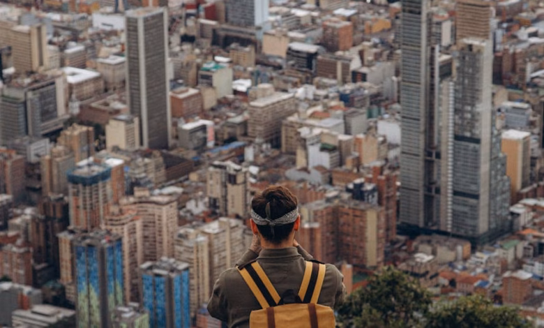 Modern city skyline with landmark architecture, riverfront buildings, and urban travel scenery at sunset for city break ideas