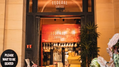 Stylish Melbourne cafe street with outdoor seating, heritage storefronts, and a lively urban coffee culture atmosphere in Aus