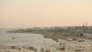 Sharm El Sheikh Red Sea beach with an Egypt resort exterior, blue sea landscape, and the Sinai mountains coastline in the dis