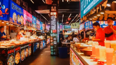 Colorful outdoor market stalls filled with fresh produce, spices, and local ingredients in a vibrant culinary travel destinat
