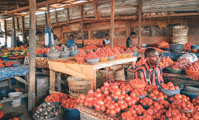 Colorful local market stalls with handmade crafts, regional goods, and hanging lanterns in a vibrant open-air shopping street