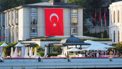 Elegant luxury hotel terrace overlooking the Bosphorus Strait and Istanbul skyline at sunset, with waterfront architecture an
