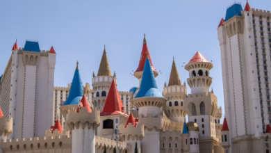Family-friendly theme park hotel exterior with colorful towers, landscaped grounds, and a resort-style entrance near attracti
