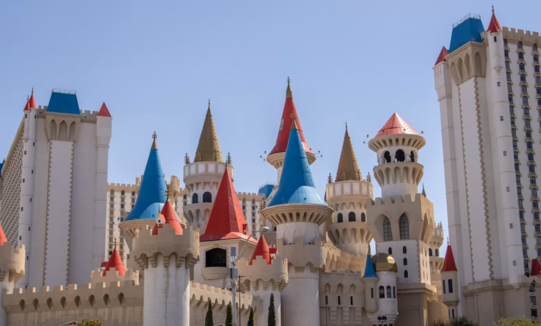 Family-friendly theme park hotel exterior with colorful towers, landscaped grounds, and a resort-style entrance near attracti