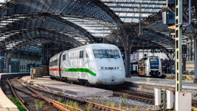 A modern train station beside a walkable city skyline, highlighting train friendly destinations with easy rail travel and urb