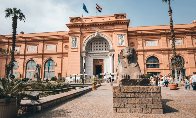 Historic Cairo museum exterior with grand neoclassical architecture, palm-lined grounds, and a landmark setting in the heart