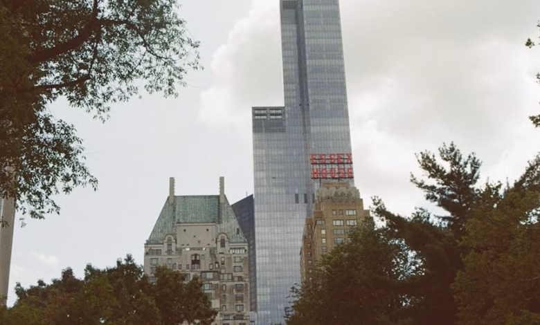 Central Park New York landscape with winding park paths, lush trees, and Manhattan skyline views under a clear urban sky