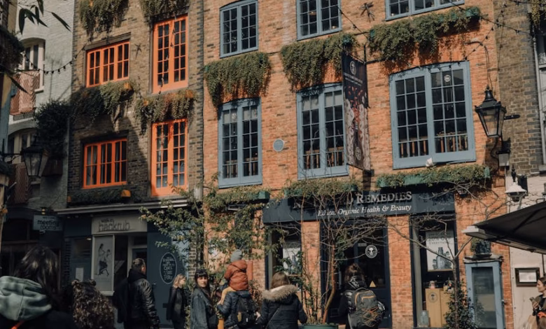 Historic Covent Garden market buildings with charming London cafe exteriors, glass storefronts, and cobblestone streets in a