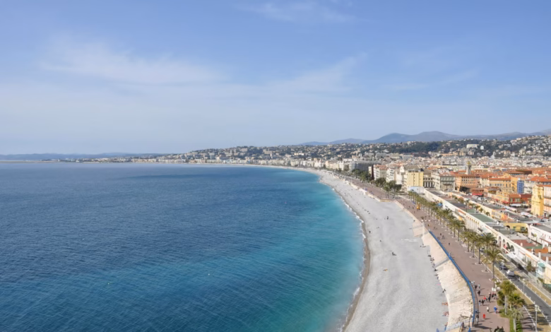 Elegant Mediterranean coastline in Nice, France, with turquoise water, sunlit promenade, and scenic French Riviera seaside vi