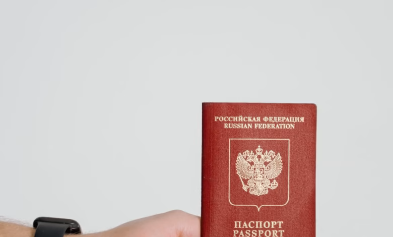 Close-up of a valid passport beside travel documents, visa forms, and an international travel checklist on a clean desk, emph