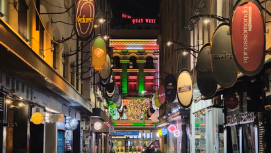 Melbourne cafe street with stylish urban storefronts, outdoor seating, and a vibrant city atmosphere reflecting the city’s co