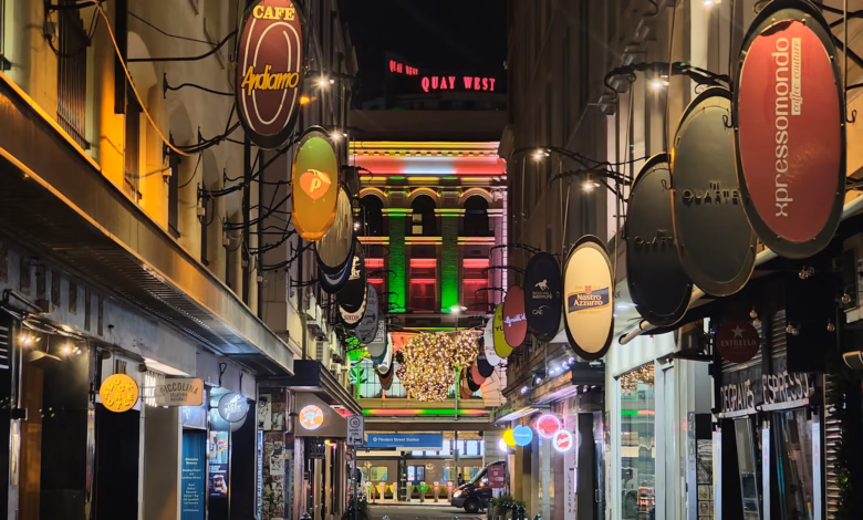 Melbourne cafe street with stylish urban storefronts, outdoor seating, and a vibrant city atmosphere reflecting the city’s co