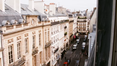 Paris city streets lined with elegant historic architecture and charming outdoor cafes in a classic French neighborhood.