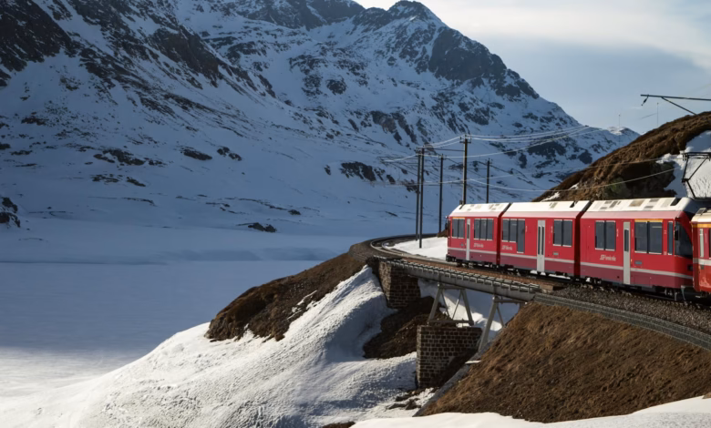 Swiss Alps train route winding through alpine valleys, snow-capped peaks, and scenic mountain railways in Switzerland