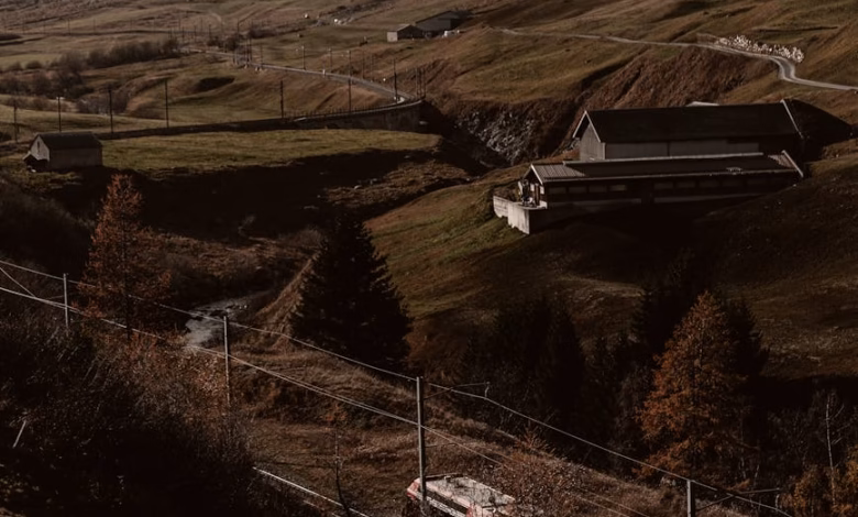 Scenic Swiss Alps train route winding through alpine valleys, with snow-capped peaks, mountain railway landscape, and dramati