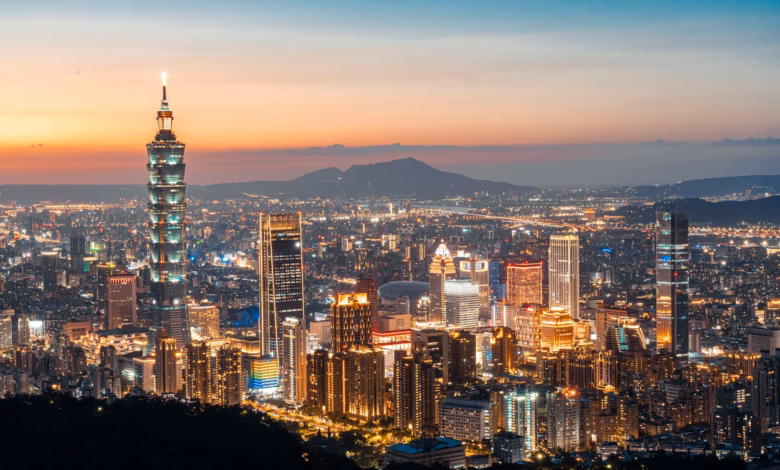 Taipei skyline at dusk with Taipei 101 rising above the city lights and surrounding urban mountains, capturing a scenic Taipe