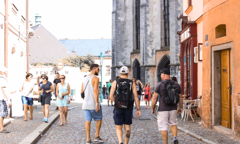 Historic cobblestone street lined with colorful buildings and a cathedral skyline, ideal for walking tour tips and comfortabl