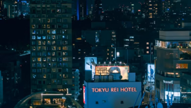 Tokyo cityscape with neon-lit skyscrapers, rail lines, and bustling urban architecture at dusk, ideal for a Tokyo travel guid