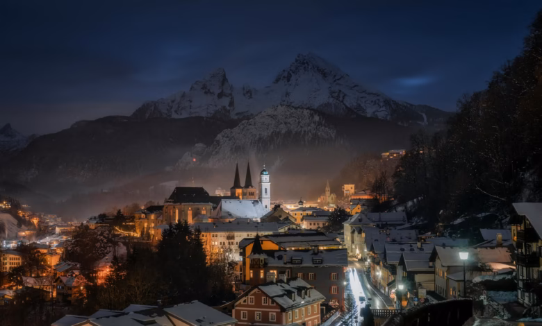 Snow-covered Swiss mountain village with chalet rooftops, alpine slopes, and a cozy European winter village atmosphere under